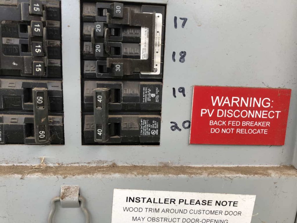 Picture of circuit breaker and identifying label to control power to the solar inverter.